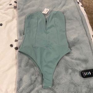 Never worn still with tags body suit